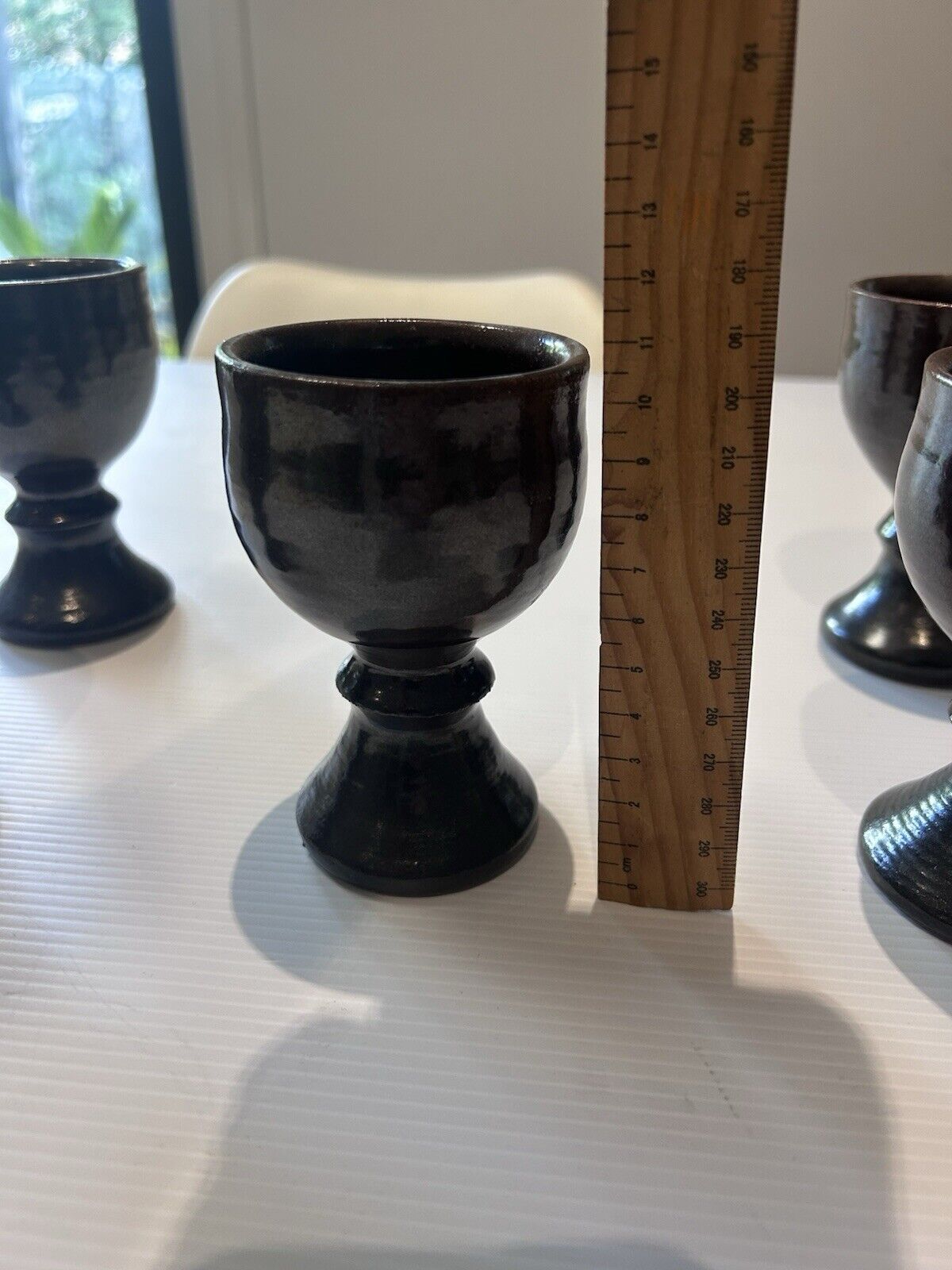 CHARLES WILTON SIGNED VINTAGE POTTERY DECANTER WITH STOPPER AND FIVE GOBLETS.